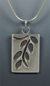 Karen, O'Brien, Karen O'Brien, Karen O'Brien Designs, jewelry, art jewelry, art, pendant, necklace, overlay, saw-pierced, pierced, sterling silver, patina, leather, snake chain, plant, leaves, branches, rectangle, rectangular, cut-out,  Austin, Texas. -  Jewelry