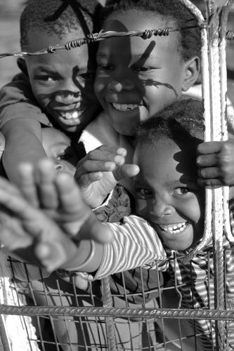 Photography-Laughing Behind a Fence